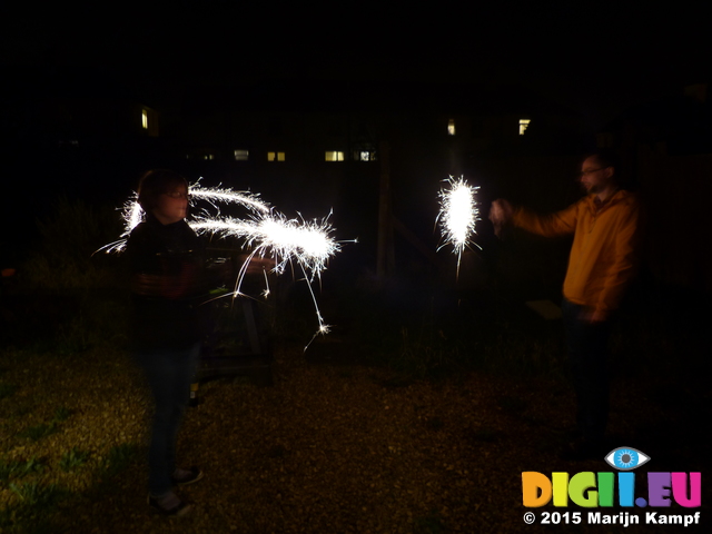 FZ024584 Jenni and Phill setting of sparklers in the garden